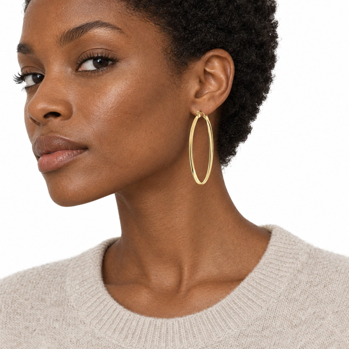 Aria Large Oval Hoop Earrings – Yellow Gold on model 2